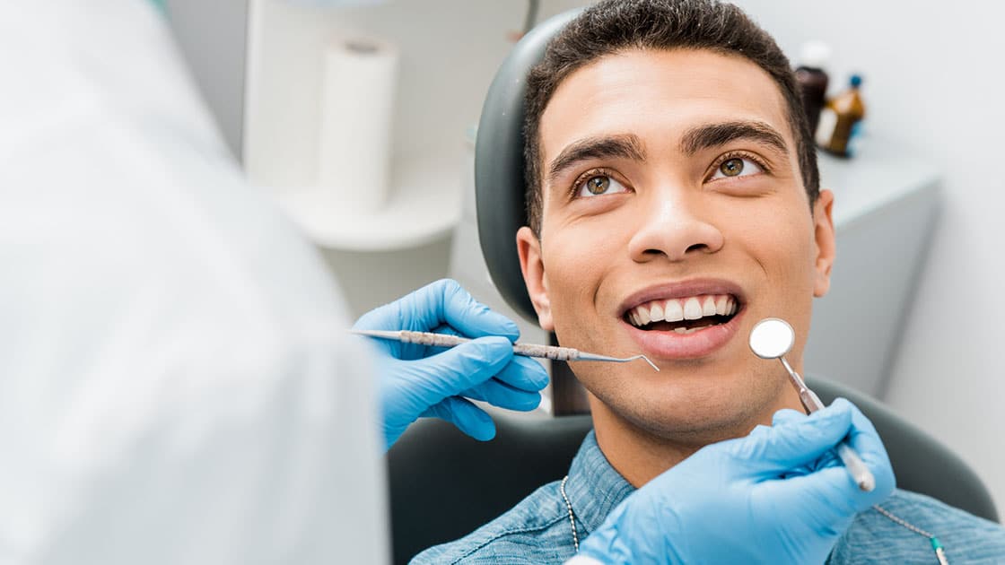 Smiling Patient In Dental Chair