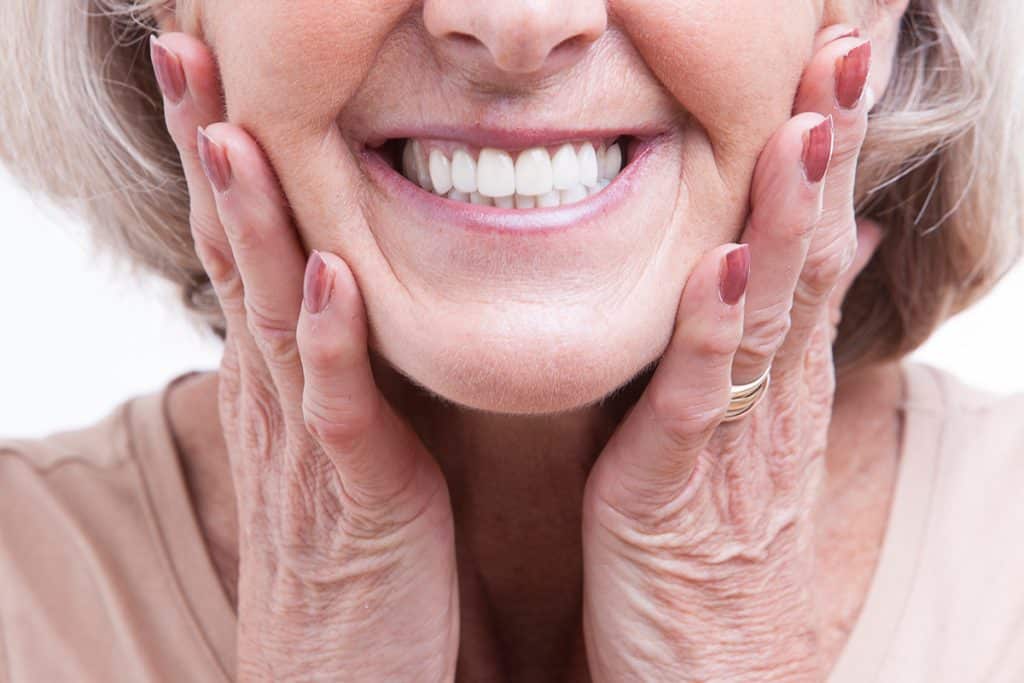 How to Prevent Sore Spots When Wearing New Dentures