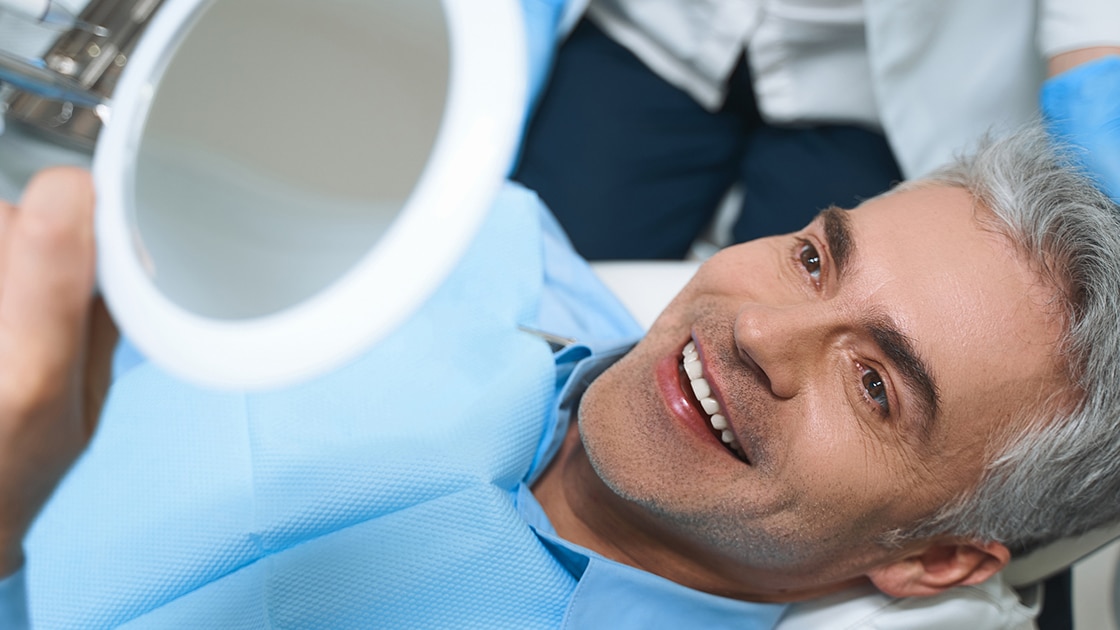 Mature Man Smilng with Dentist